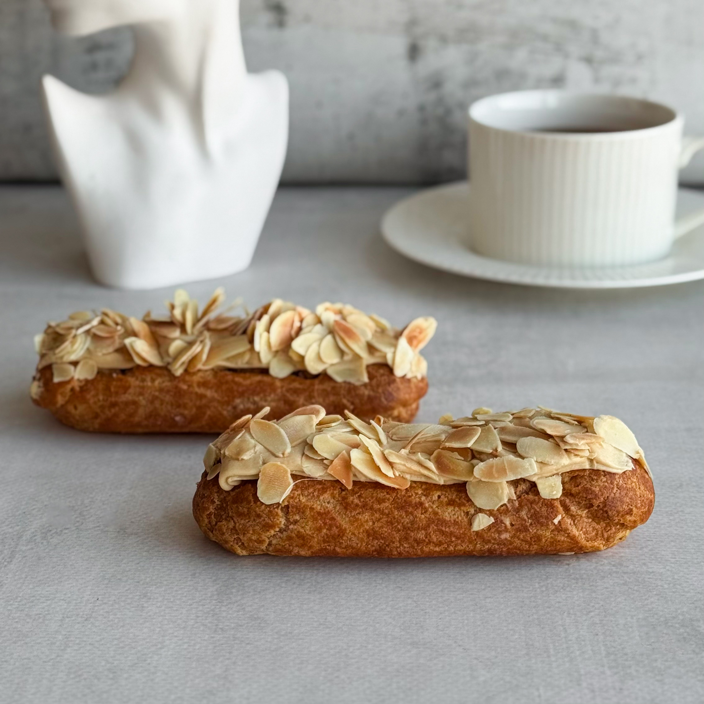 Карамельный эклер с кремом из взбитых сливок с карамелью, украшенный лепестками миндаля изображение 5