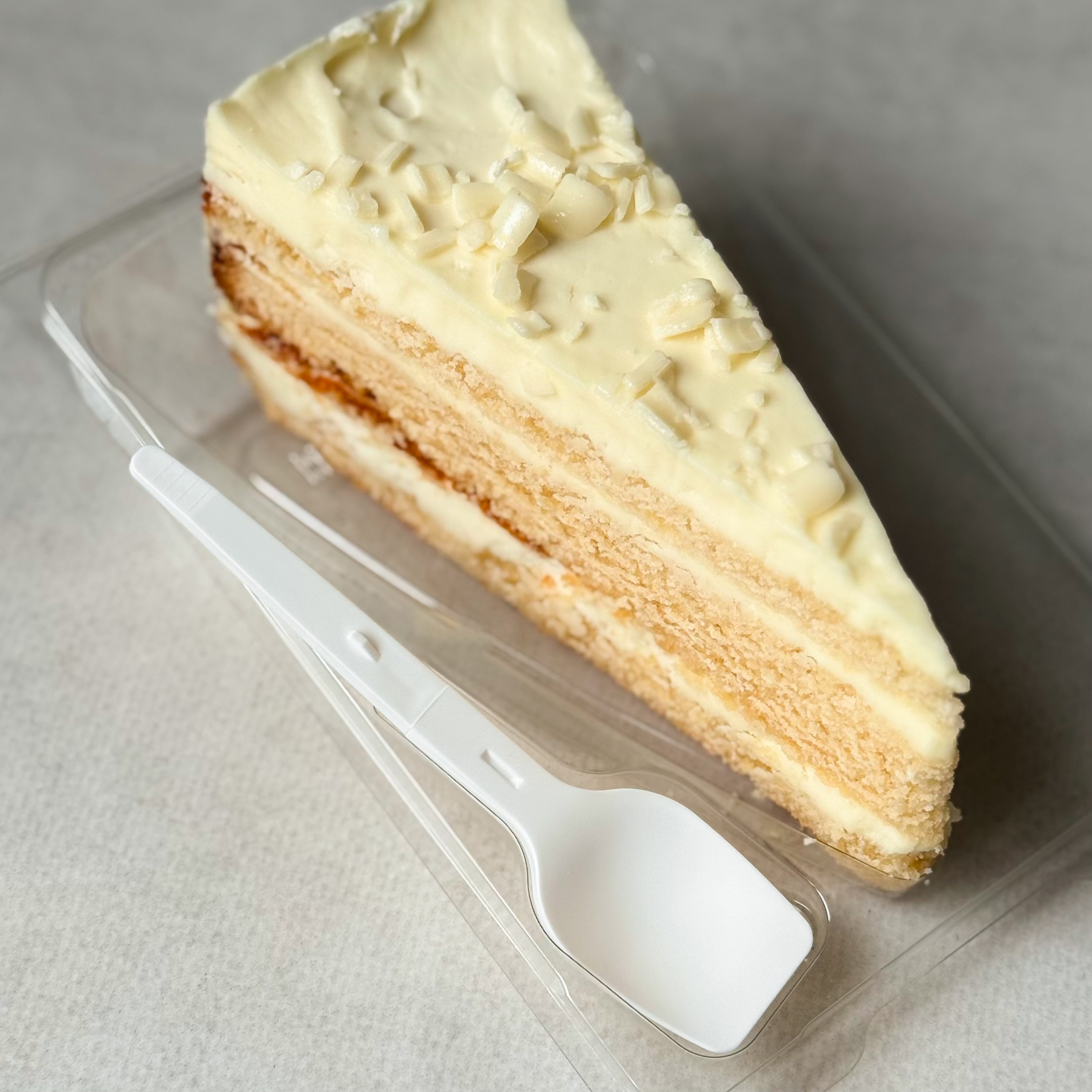 Изысканный торт из слоев нежного бисквита и творожного крема. Сверху торт украшен посыпкой из белого шоколада. изображение 3